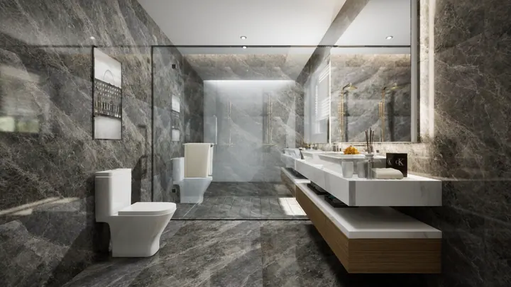 Bathroom clad in grey marble with a twin floating vanity, backlit mirror and a walk-in shower