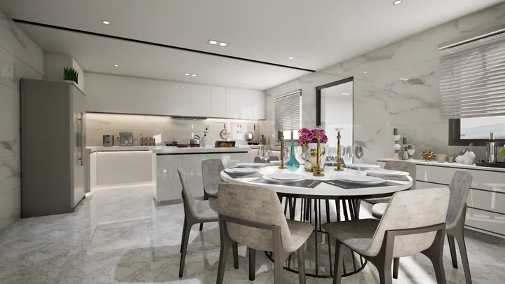 Dining area opening onto a modular kitchen, with marble-clad walls and a round dining table