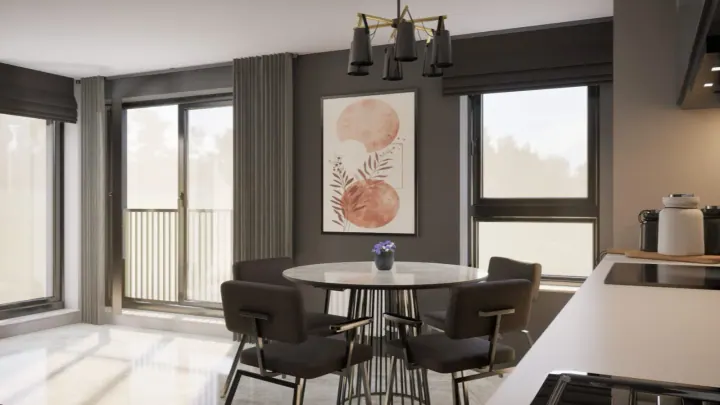 Round dining table by the window with black chairs and a small chandelier