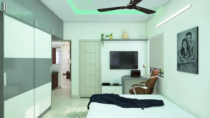 Compact workspace built into a bedroom with a wall-mounted desk and task lighting