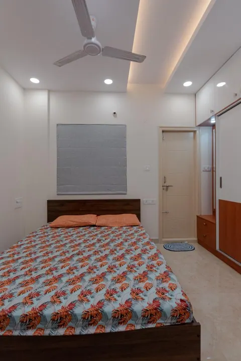 Master bedroom with a laminate bed, sliding wardrobe and recessed ceiling lights
