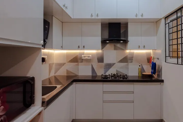 Modular kitchen showing tall unit storage and under-cabinet lighting