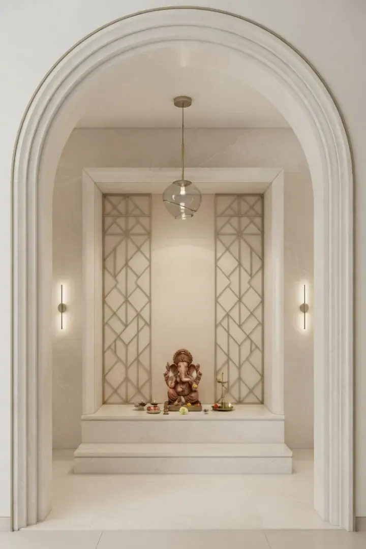Arched white pooja niche with a jaali panel and pendant light