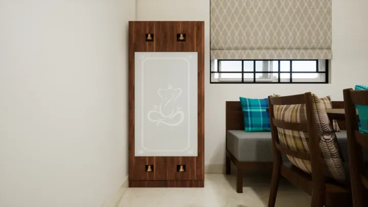 Compact pooja panel with an Om engraving beside the dining area