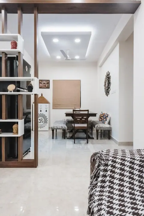 Compact pooja unit placed in the dining corner of a 2BHK home