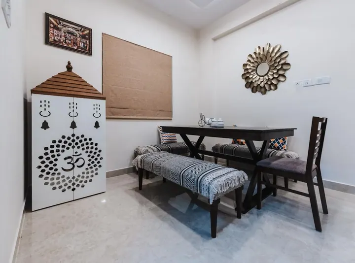 Pooja unit in white with a laser-cut Om jaali and a carved wooden gopuram top