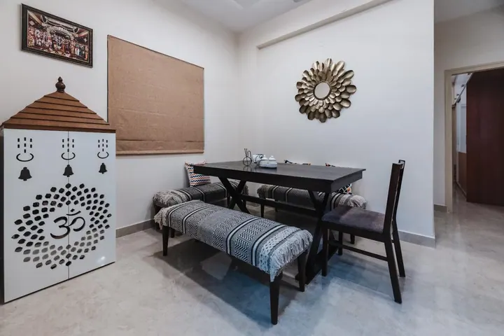 Wide view of a pooja unit with framed deity art alongside